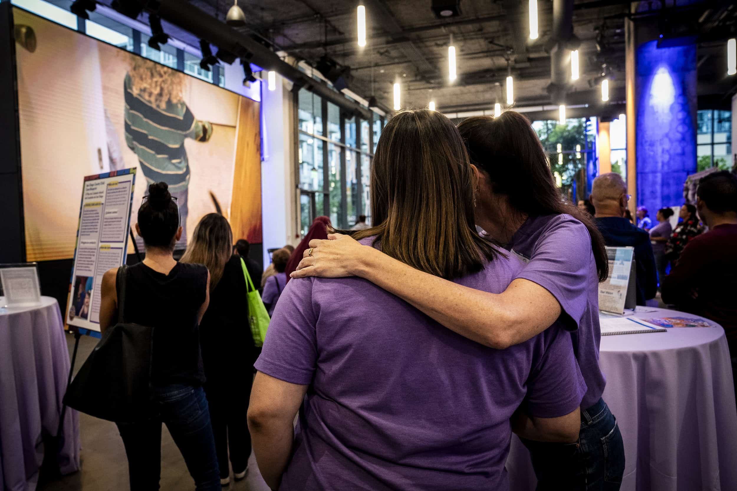 Advocates embrace at the We Choose Care event