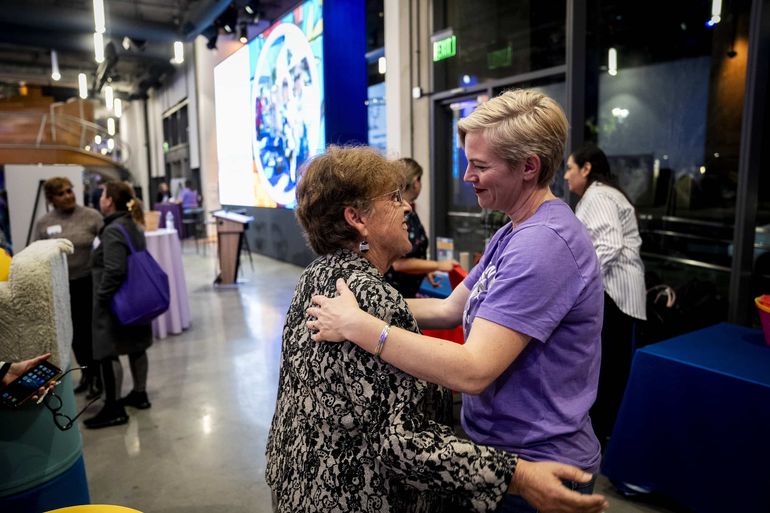 Advocates embrace one another at the We Choose Care community event